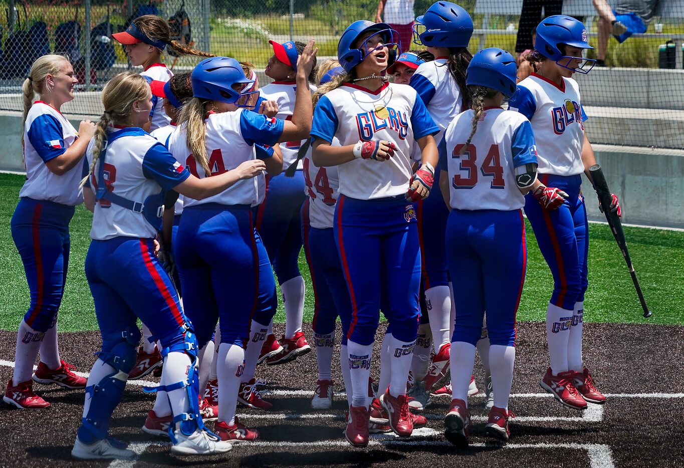 Texas Glory 18U players, including shortstop Jayda Coleman (facing at center) celebrate...