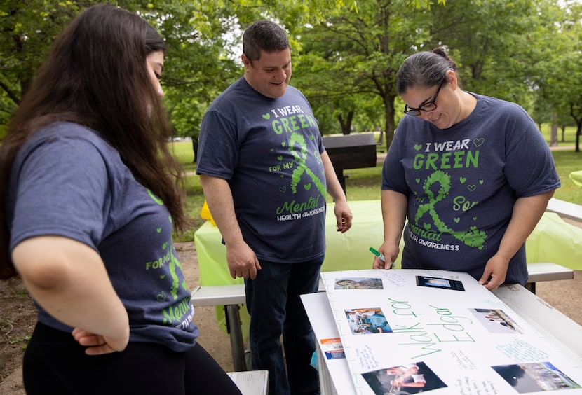 Stefania Tirado (from left), Edgar Tirado Sr. and Susana Tirado looked at an old baby photo...