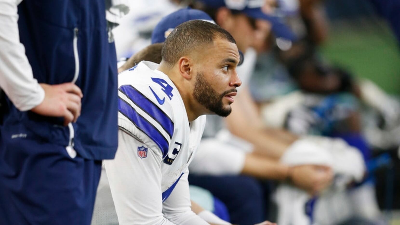 FILE - Cowboys quarterback Dak Prescott (4) sits on the bench during the second half of a...