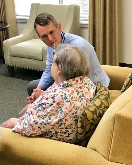 A staff volunteer speaks with an older resident as part of The Senior Source Long-Term Care...