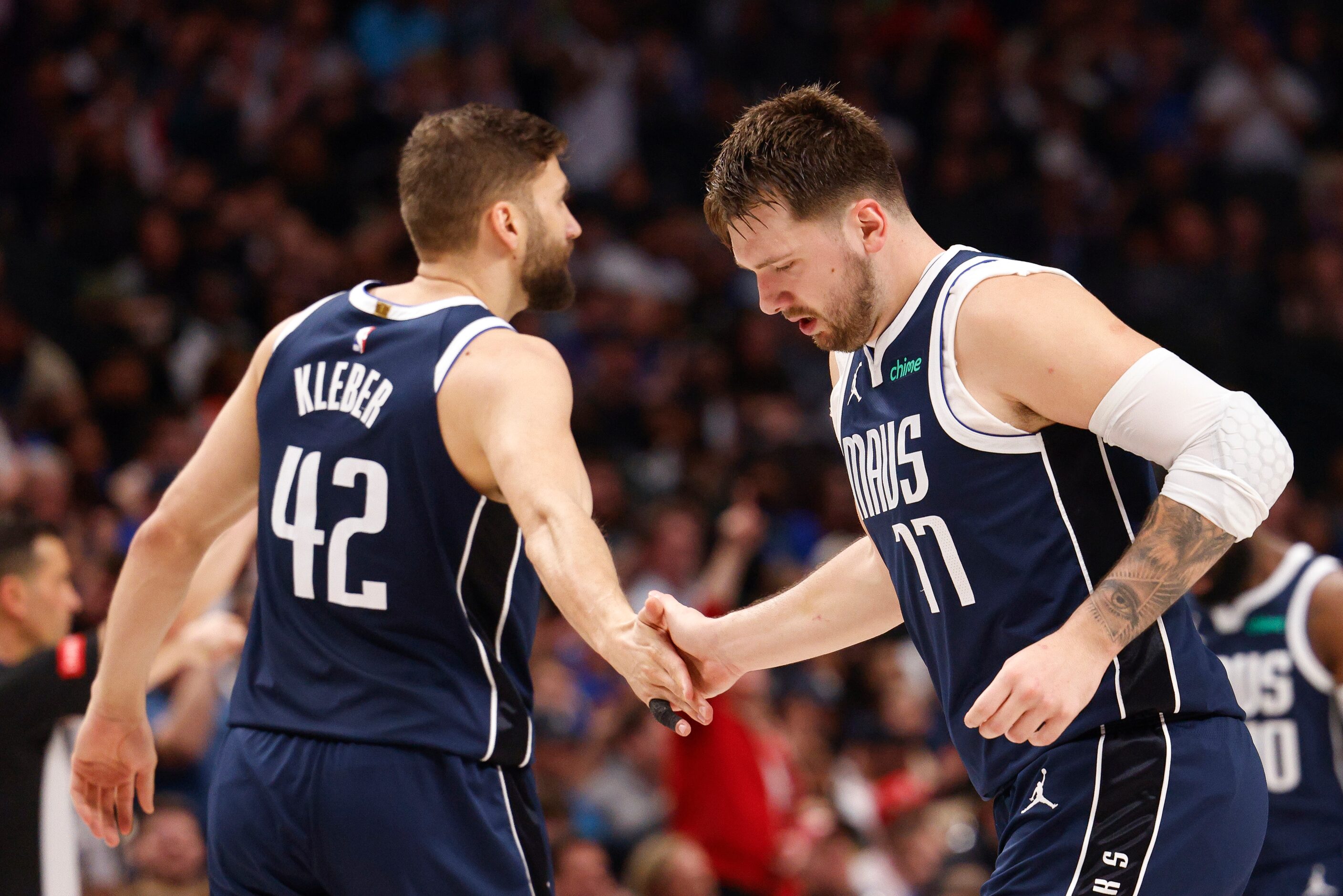 Dallas Mavericks guard Luka Doncic (77) high fives forward Maxi Kleber (42) during the...