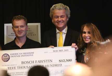 Artist Bosh Fawstin, left, is presented with a check by Dutch politician Geert Wilders,...
