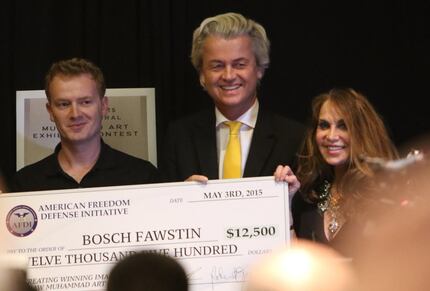 Artist Bosh Fawstin, left, is presented with a check by Dutch politician Geert Wilders,...