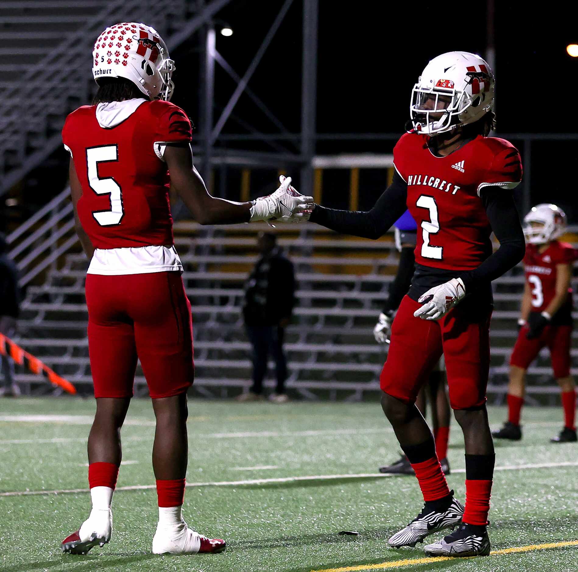 Hillcrest wide receiver Shannon Cruse (5) and running back Reggie Williams (2) greet each...