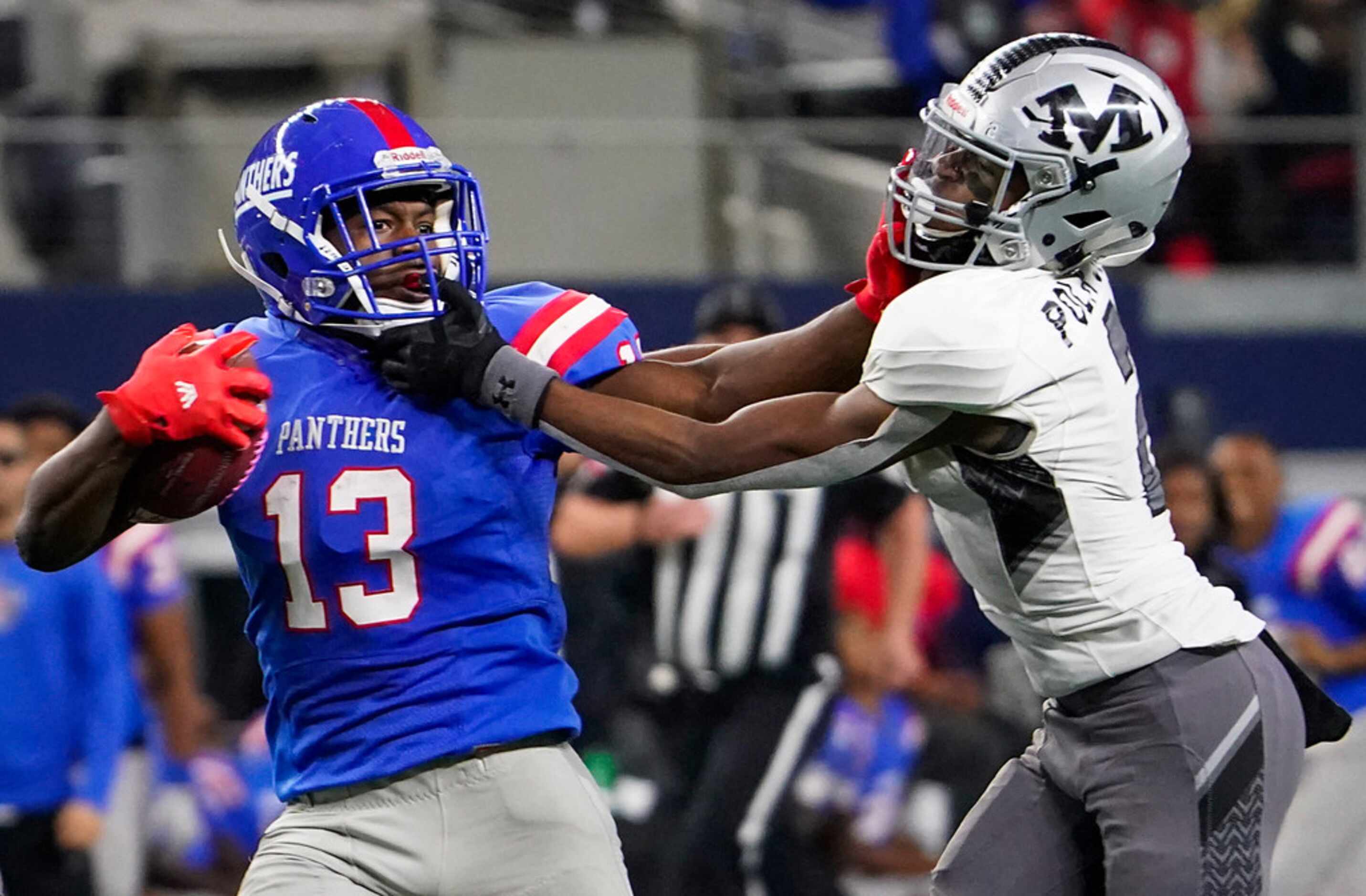 Duncanville wide receiver Roderick Daniels (13) is brought Arlington Martin defensive back...