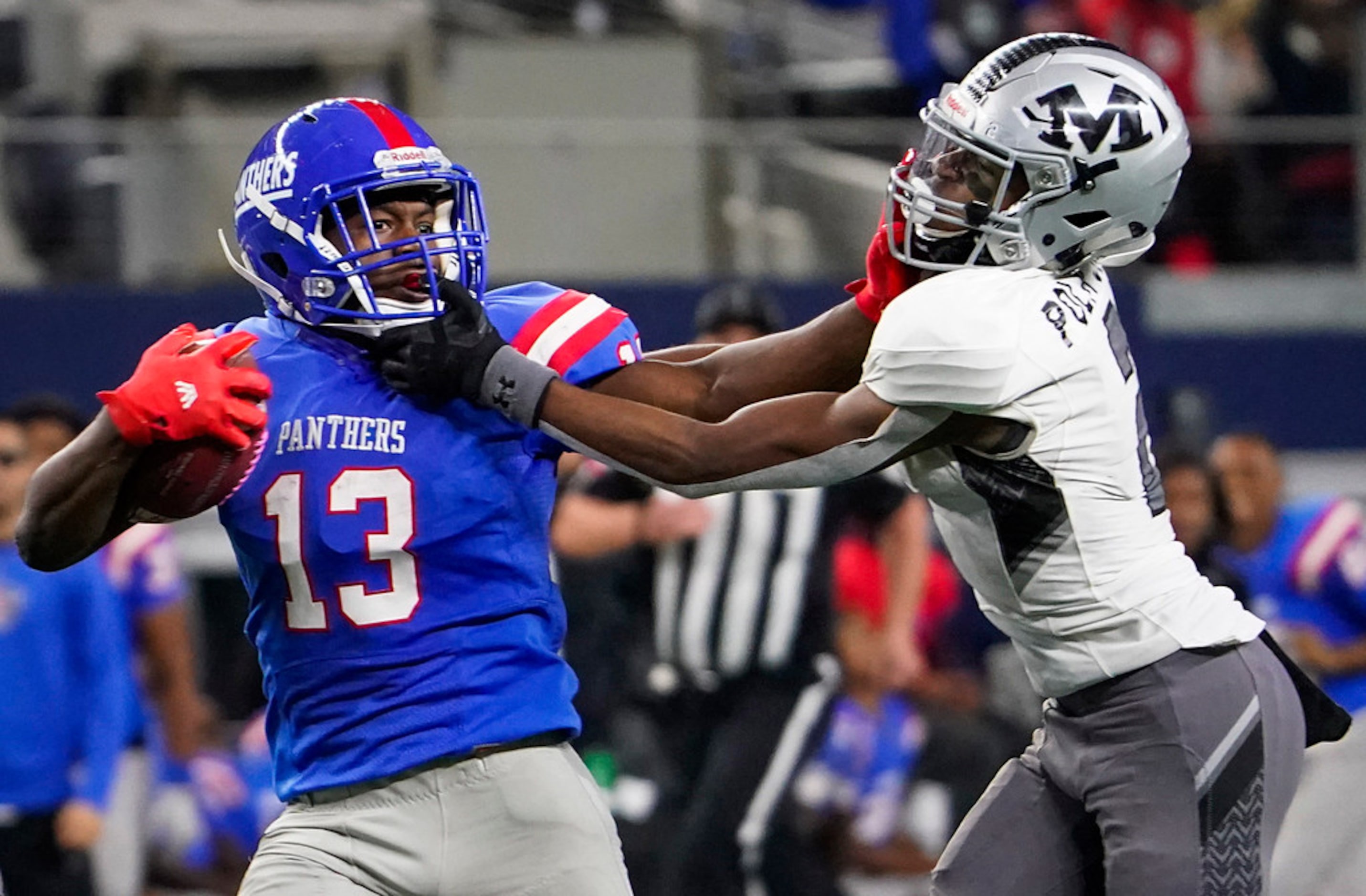 Duncanville wide receiver Roderick Daniels (13) is brought Arlington Martin defensive back...