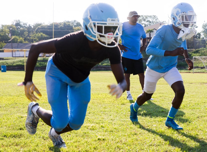 Roosevelt head coach Aaron Wallace, center, looks on as his team practice on Wednesday,...