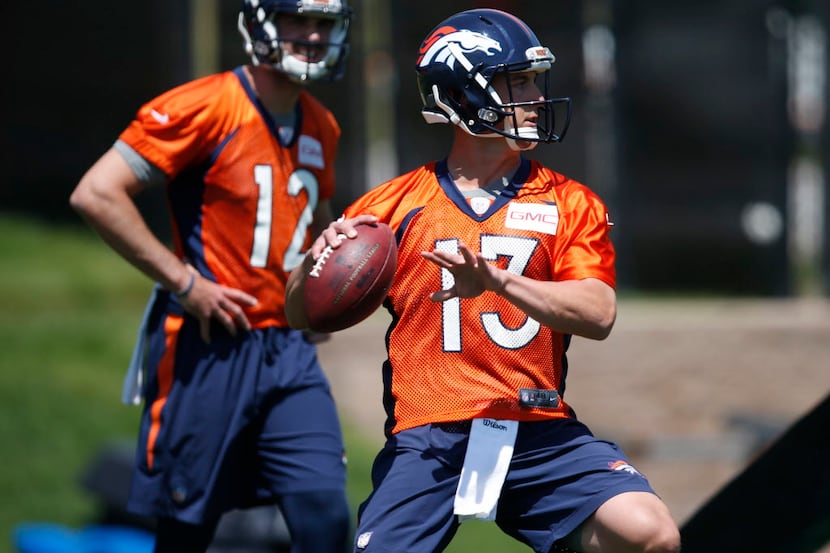 Denver Broncos quarterback Trevor Siemian, front, looks to pass the ball as rookie...