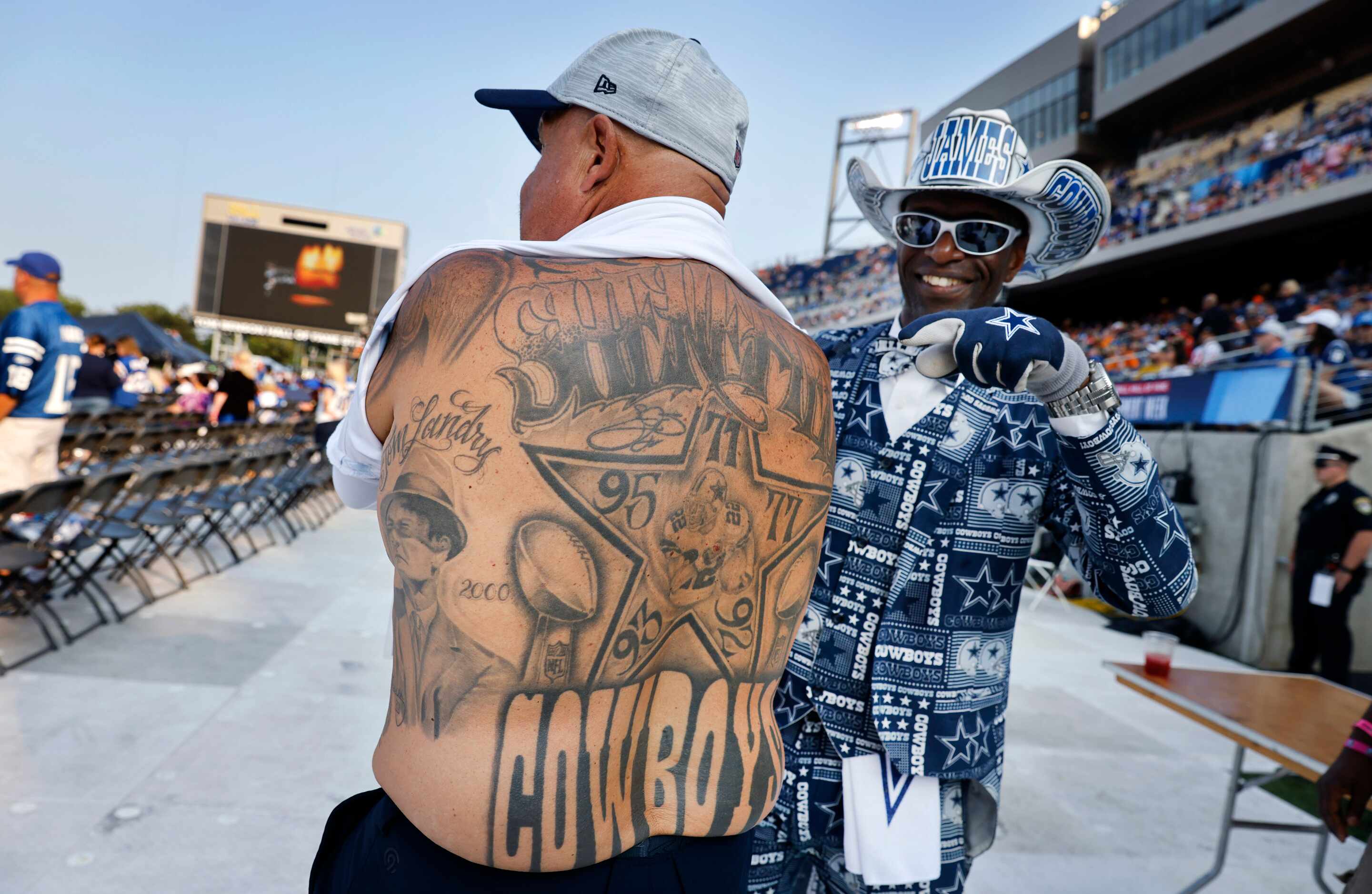 Mark Shenefild shows off his Dallas Cowboys themed tattoos covering his back as pointed out...