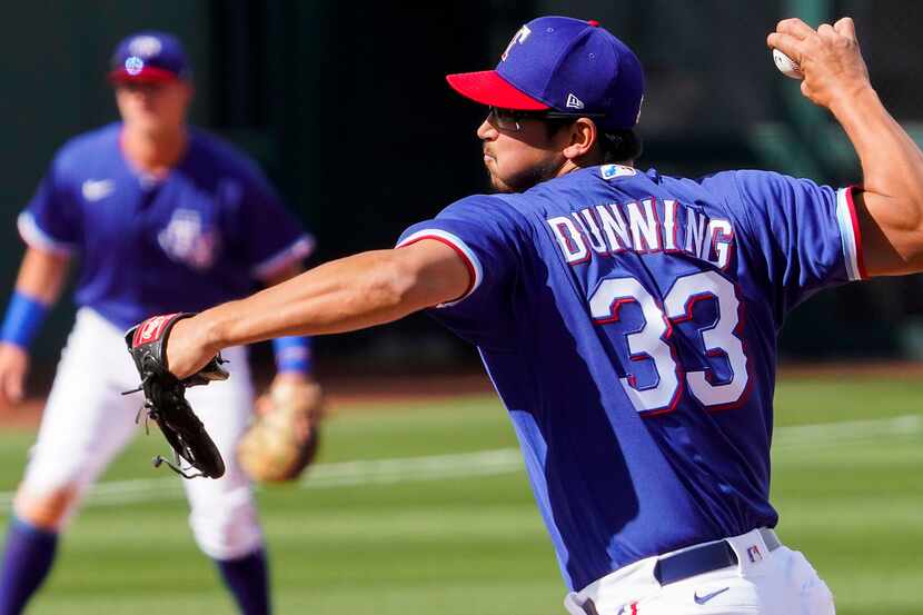 Texas Rangers pitcher Dane Dunning delivers during the seventh inning of a spring training...