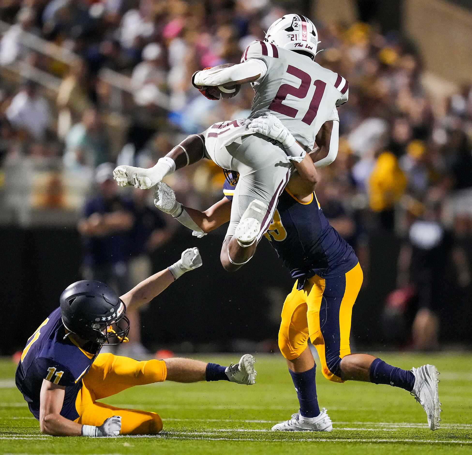 Lewisville running back Viron Ellison (21) is stopped as he tries to leap Highland Park...