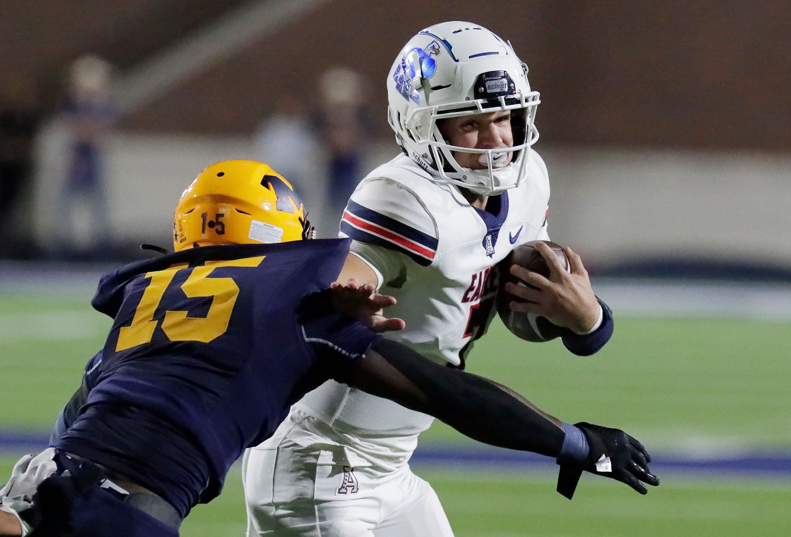 Allen High School quarterback Brady Bricker (7) was able to slip away from McKinney High...