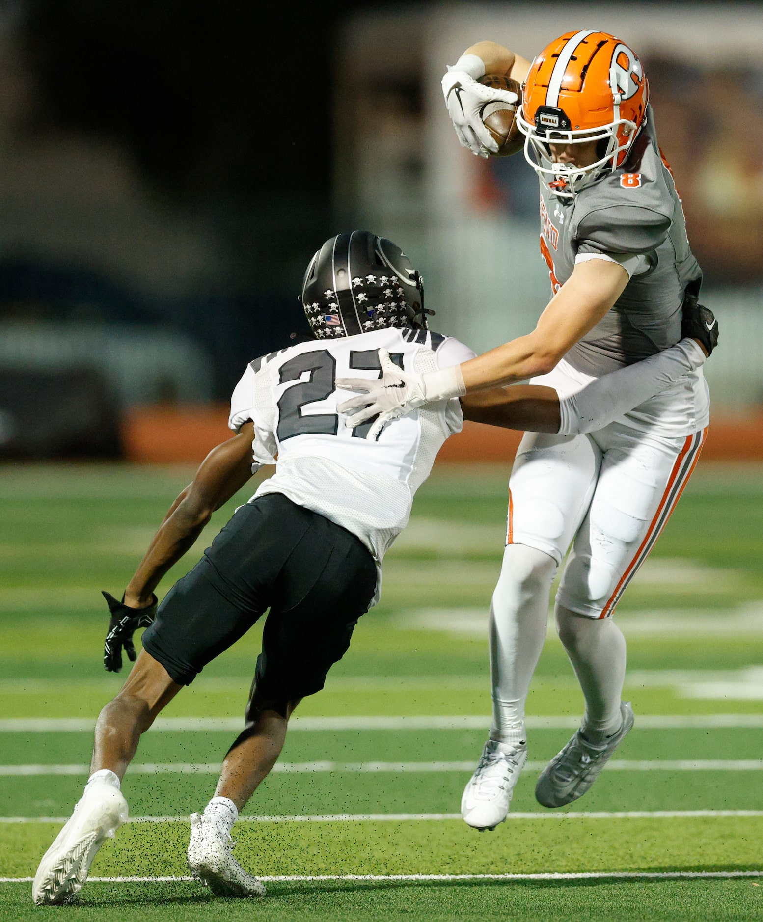 Rockwall wide receiver Triston Gooch (8) jumps through a tackle from North Forney’s Gianni...