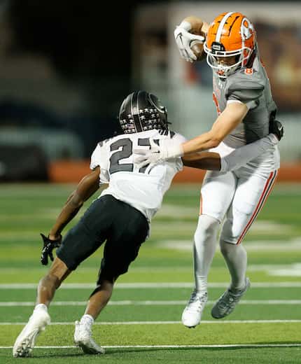 Rockwall wide receiver Triston Gooch (8) jumps through a tackle from North Forney’s Gianni...