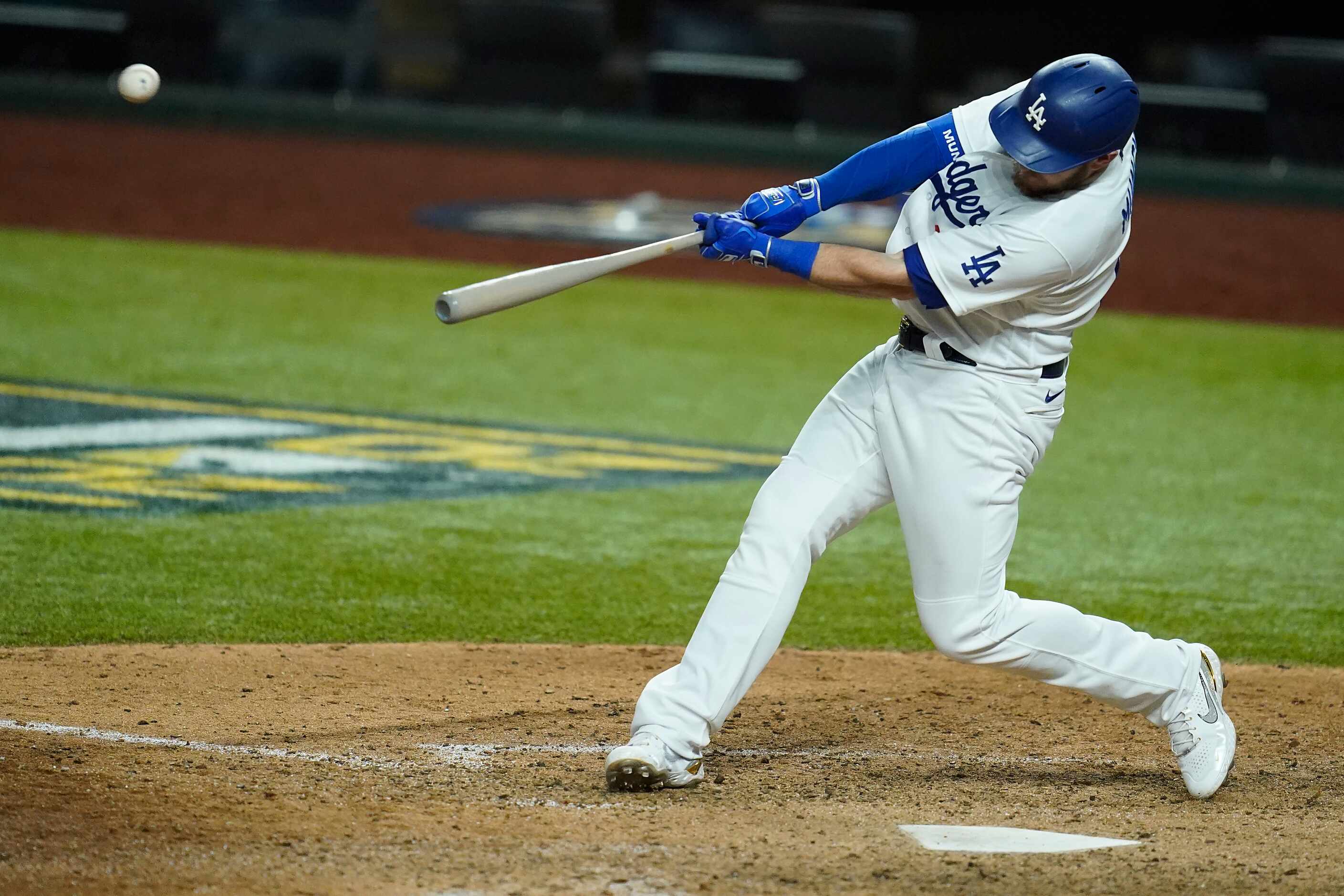 Los Angeles Dodgers first baseman Max Muncy hits a 2-run home run during the ninth inning...