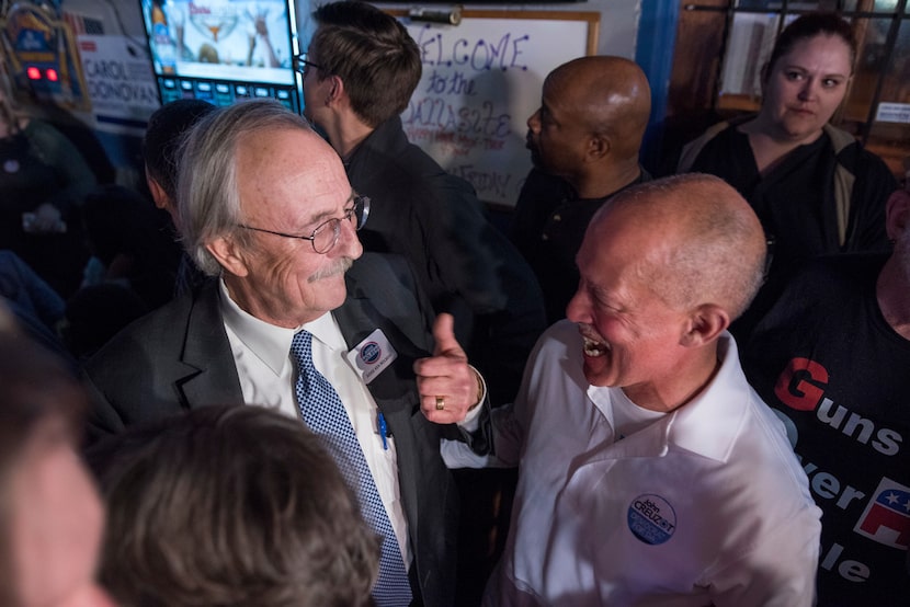 Justice Ken Molberg (left) celebrates with John Creuzot during a watch party at the Dallasite.