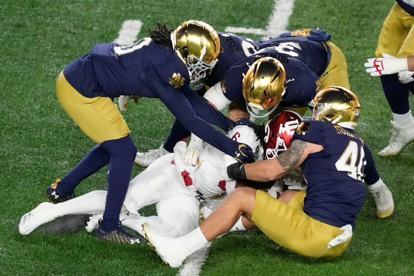 Notre Dame defenders stop Indiana running back Justice Ellison (6) during the first half in...