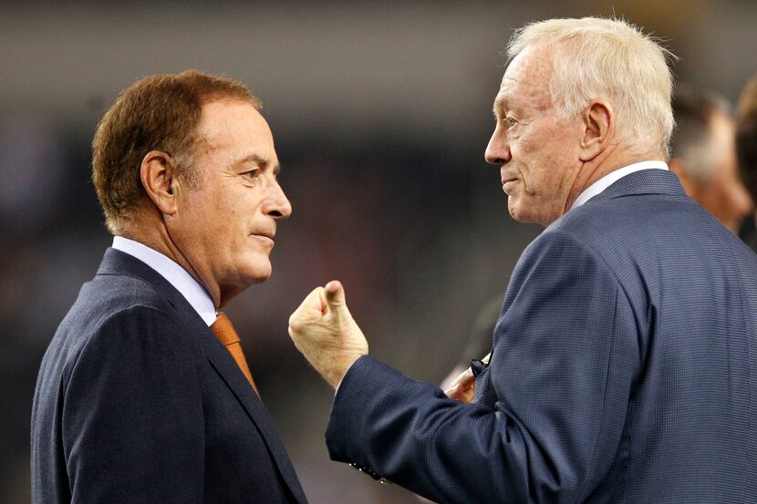 Dallas Cowboys owner Jerry Jones talks to television analyst Al Michaels before a game...