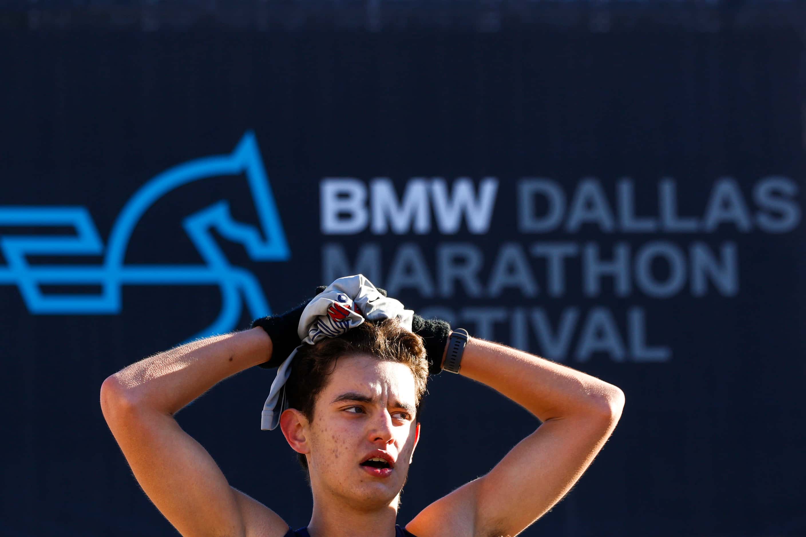 Half marathon runners catch their breath as they reach the finish line during 2023 BMW...