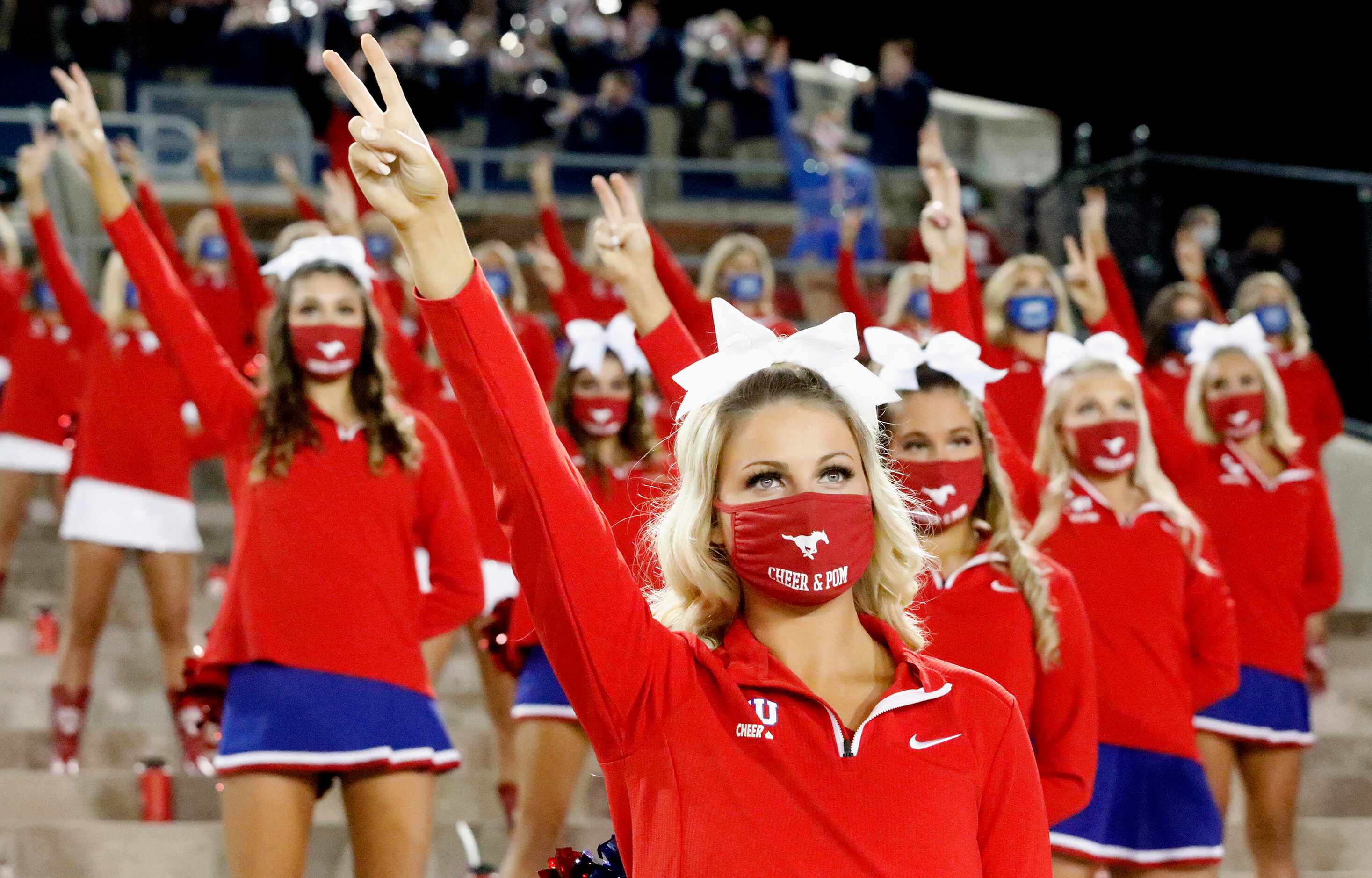 Members of the Cheer and Pom squad cheer their team on during the first half as SMU hosted...
