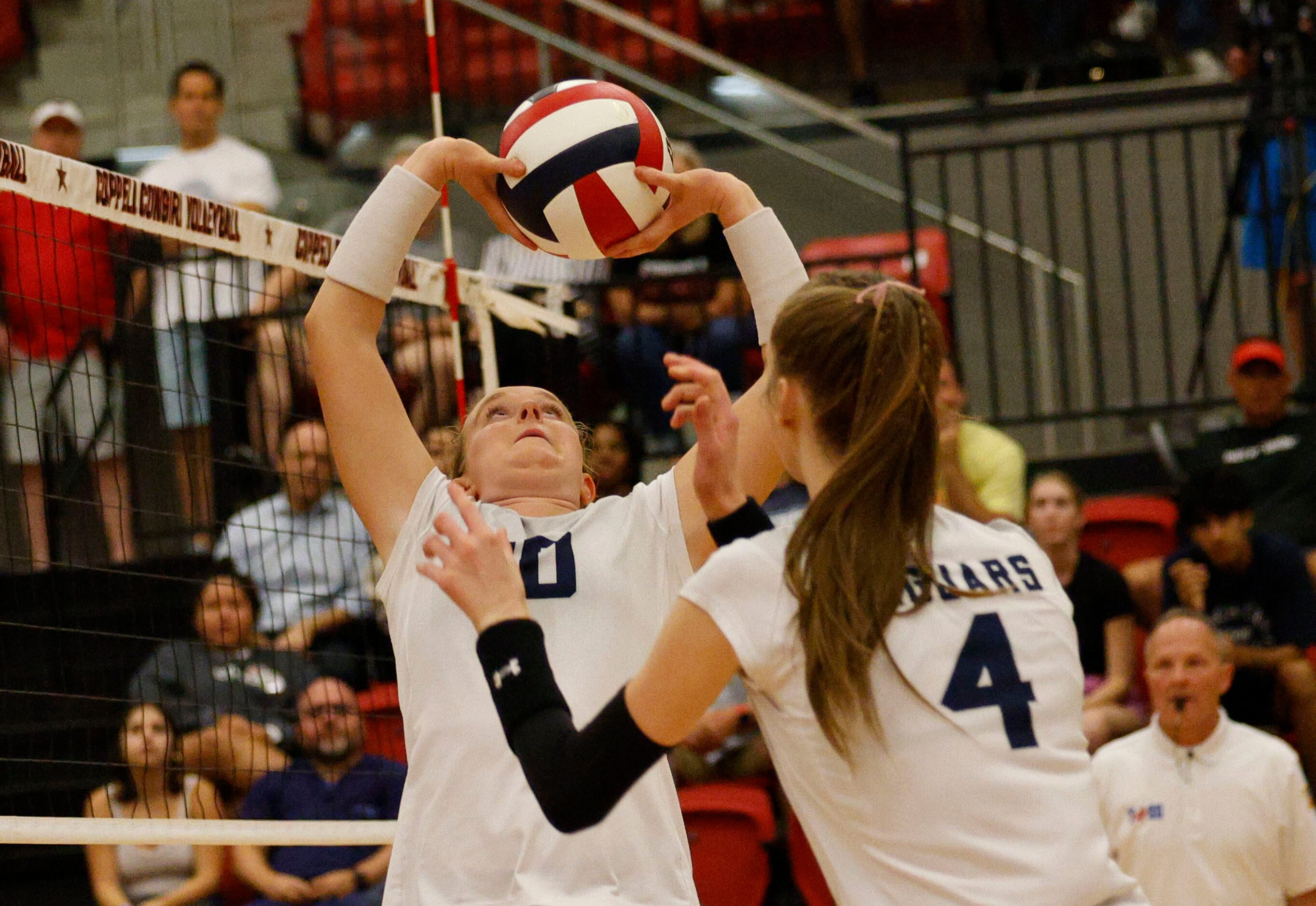 Flower Mound's Chloe O'Brien (10) sets the ball as Flower Mound's Caroline Tredwell (4)...