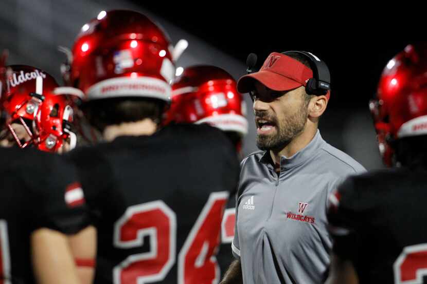 Woodrow Wilson coach Tony Benedetto talks with his team before the opening kickoff against...