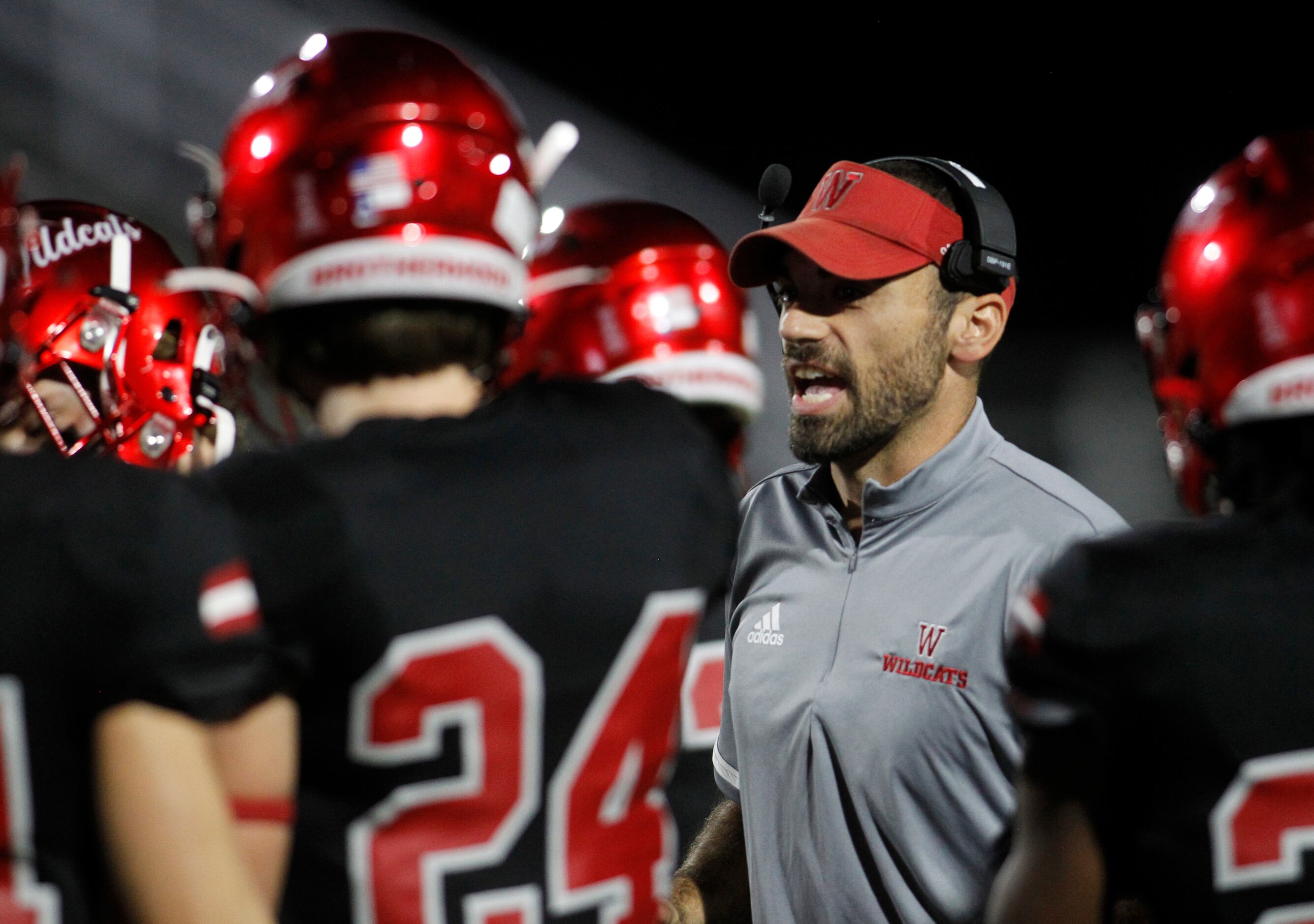Dallas Woodrow Wilson head coach Tony Benedetto parts with last minute instructions just...