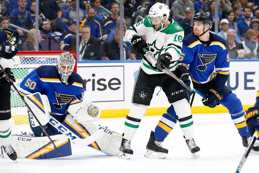 Dallas Stars center Jason Dickinson (16) tries to deflect a shot past St. Louis Blues...