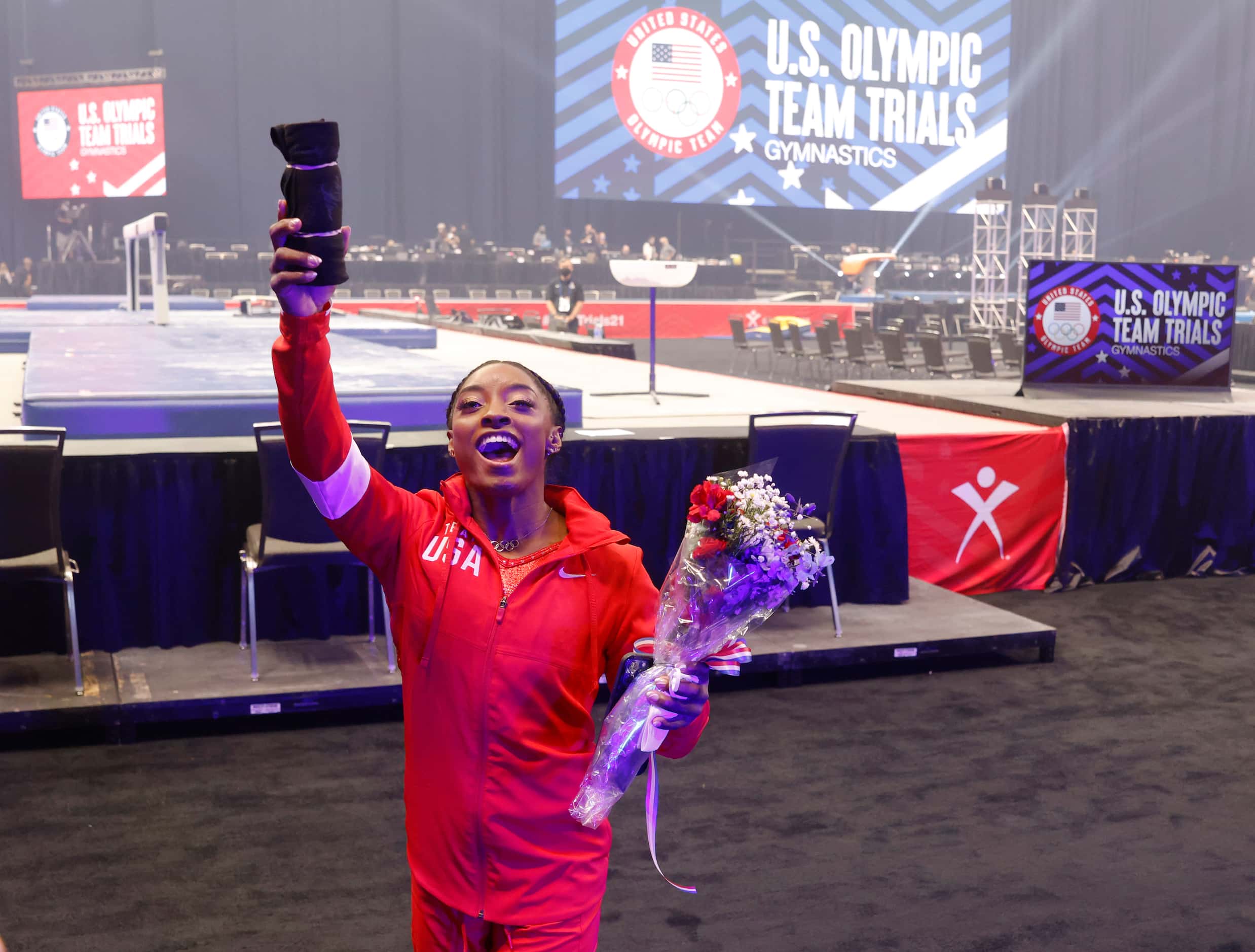 Simone Biles tosses a shirt in the stands after team introductions on day 2 of the women's...