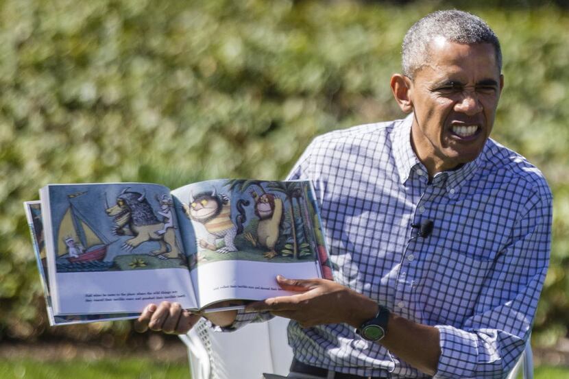President Barack Obama reads the book "Where the Wild Things Are" to a group of children...
