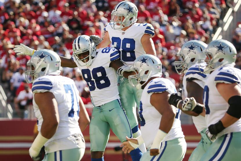 Dallas Cowboys strong safety Jeff Heath (38) celebrates with wide receiver Dez Bryant (88)...