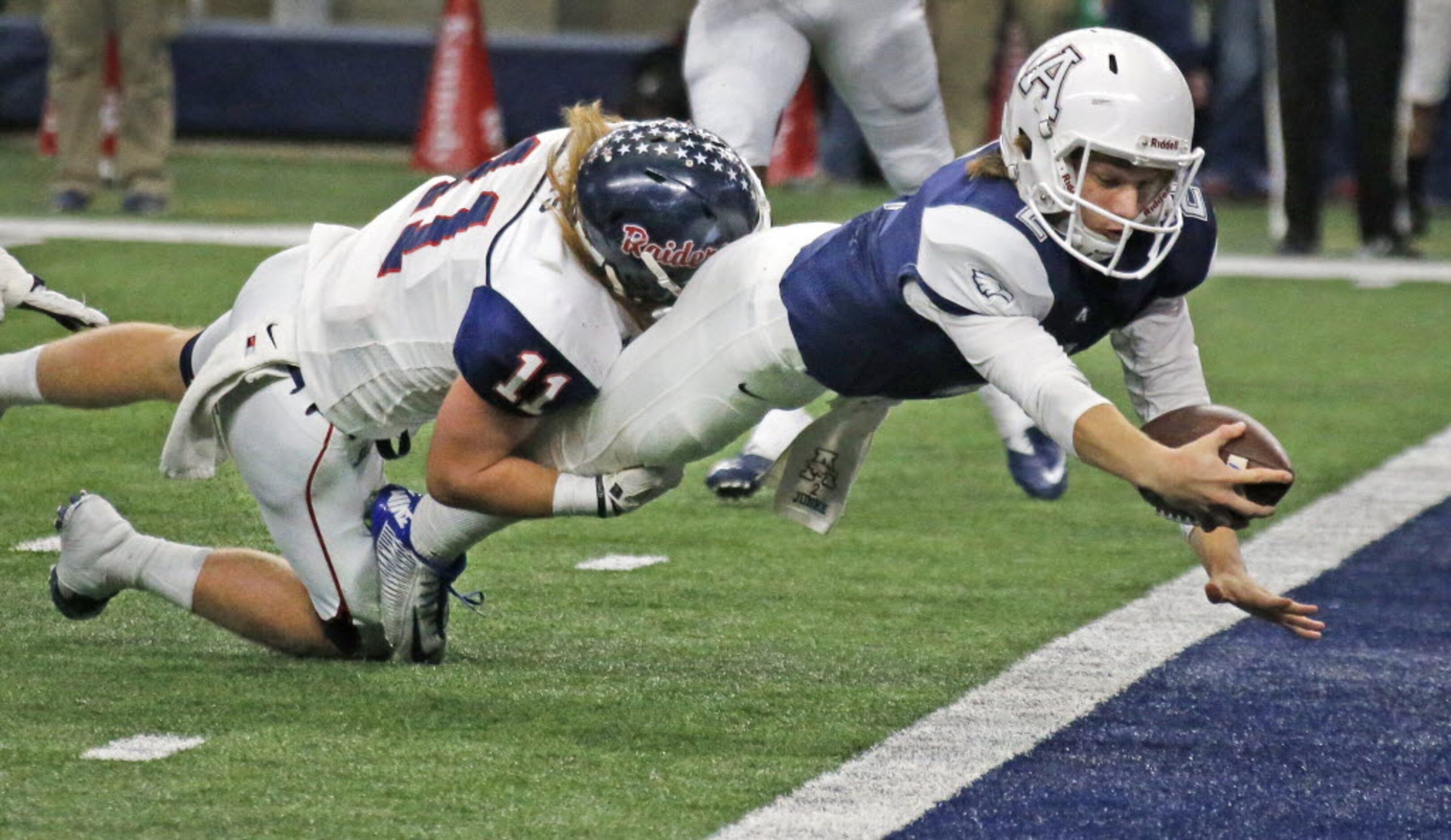 Allen quarterback Mitchell Jonke (2) dives for a touchdown as Ryan linebacker Nick Watts...