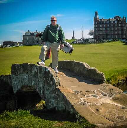 Doug Bolls poses on the swilcan bridge on the way to the 18th green at St. Andrews during a...