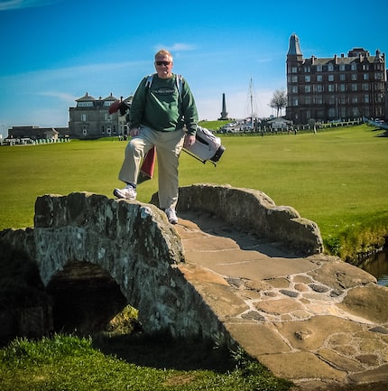 Doug Bolls poses on the swilcan bridge on the way to the 18th green at St. Andrews during a...