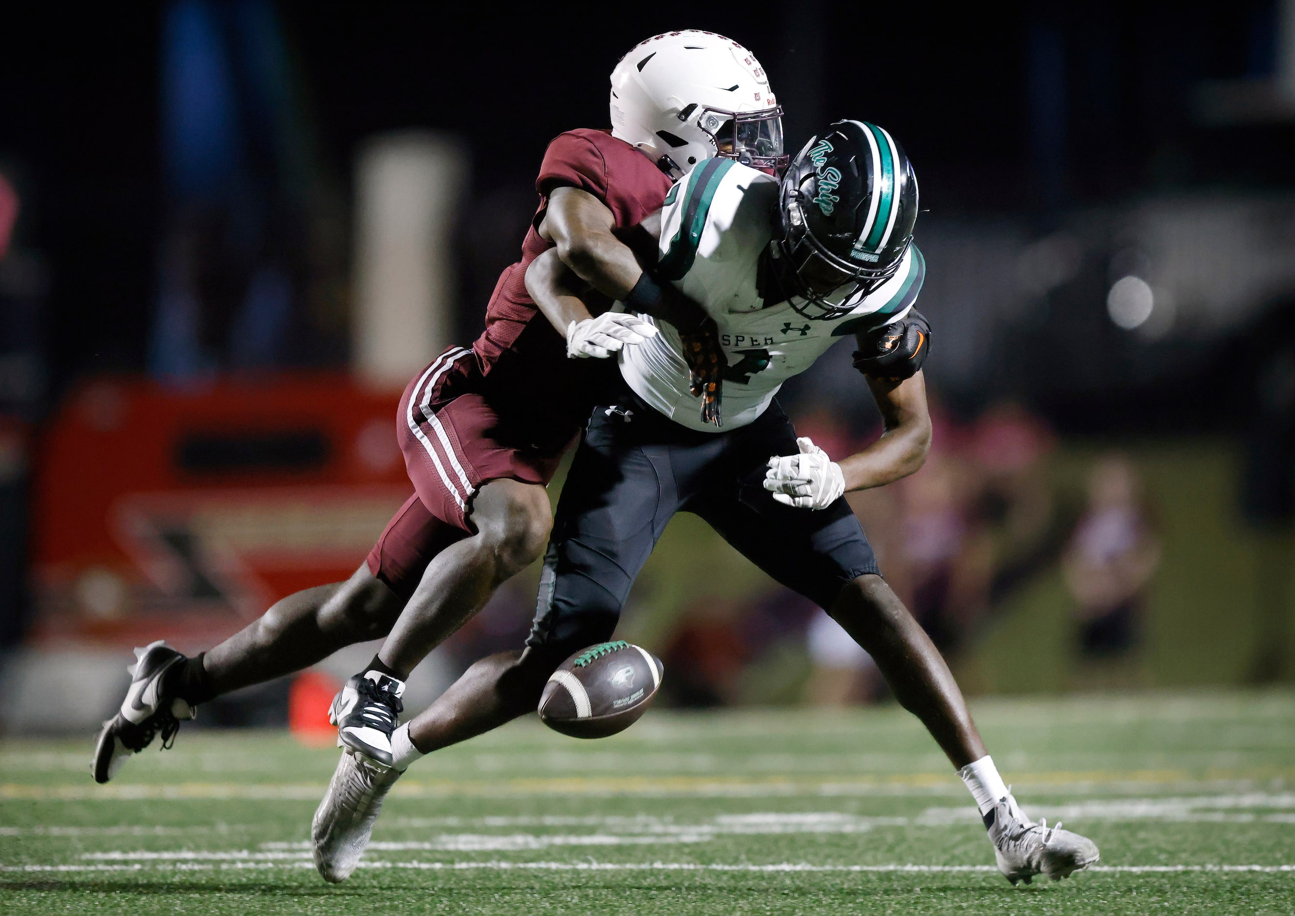 Plano High defensive back Rohon Kazadi (left) knocks a pass loose that was initially caught...