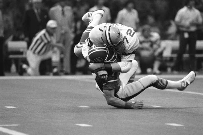 Denver Broncos quarterback Craig Morton (7) is hit hard by Dallas Cowboys defensive end Ed...