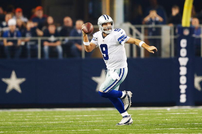 Dallas Cowboys quarterback Tony Romo (9) breaks away from the pocket to run for a first down...
