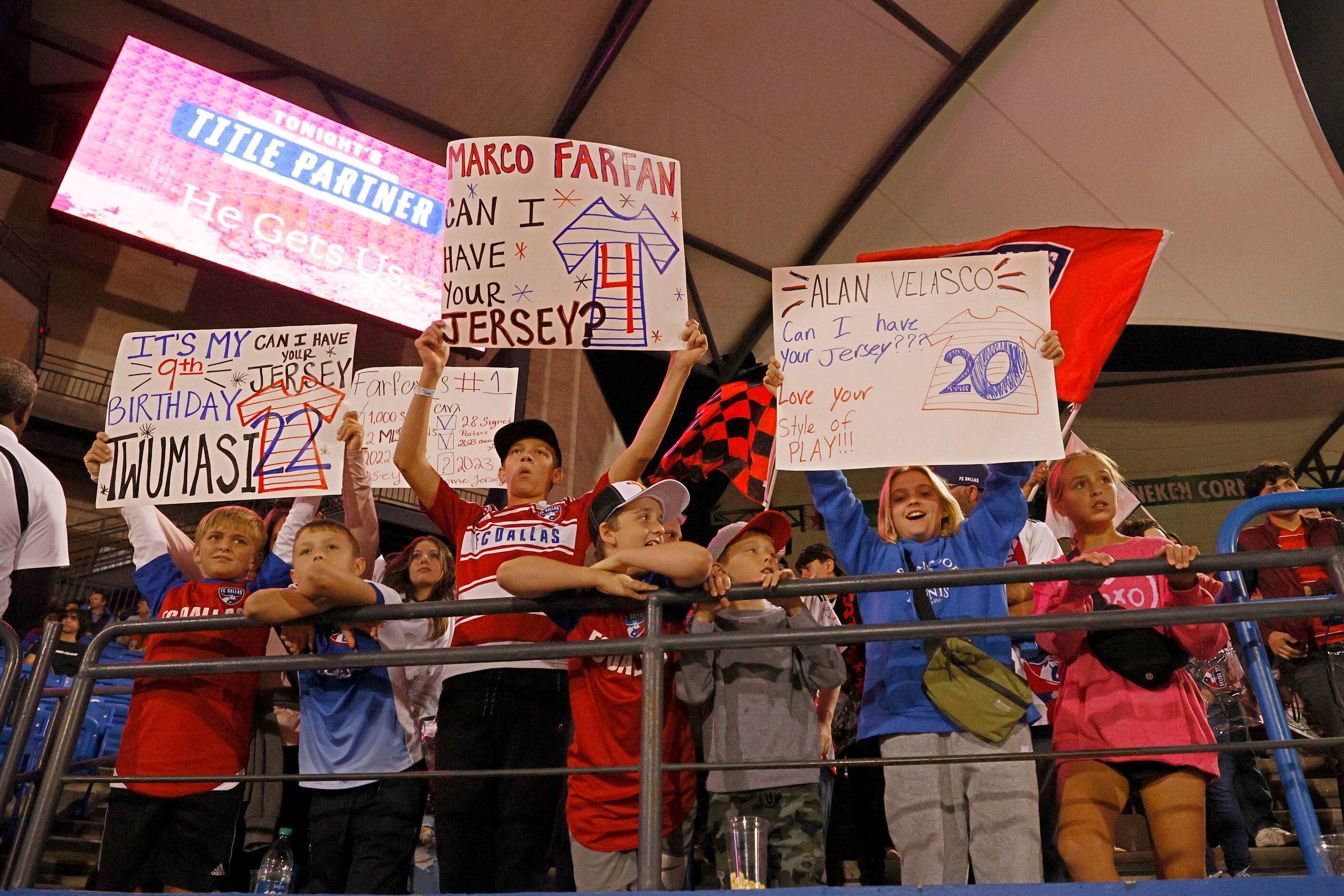 Fans hold signs before an MLS soccer match between FC Dallas and San Jose Earthquakes at...