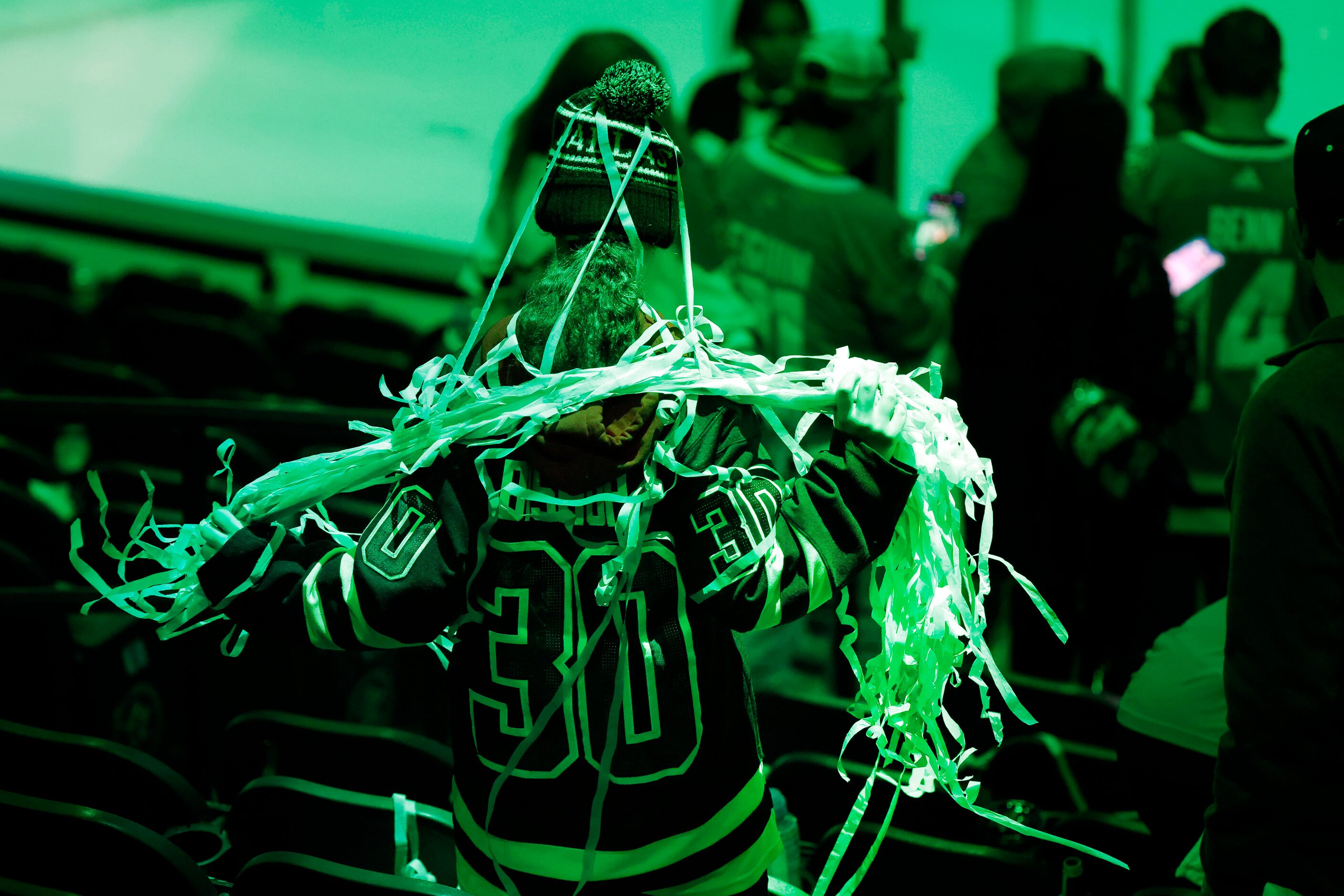 A Dallas Stars fan collects the paper streamers as a souvenir following the teams 7-3 win...