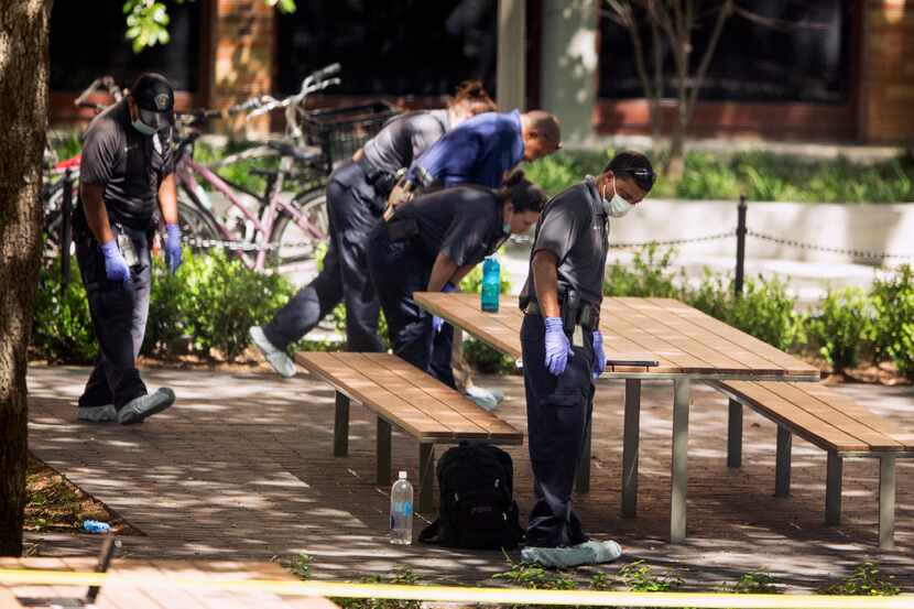 FILE - In this May 1, 2017, file photo, officials investigate after a fatal stabbing attack...