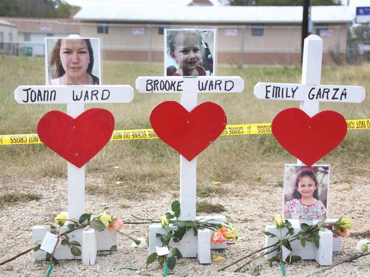 Wooden crosses honor the 26 shooting victims near First Baptist Church of Sutherland Springs...