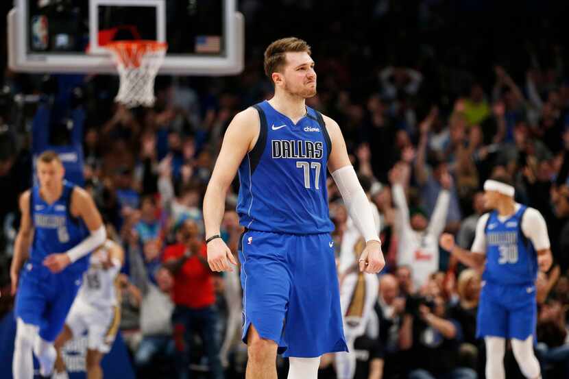 FILE - Mavericks guard Luka Doncic (77) smiles after making a 3-pointer late in overtime...