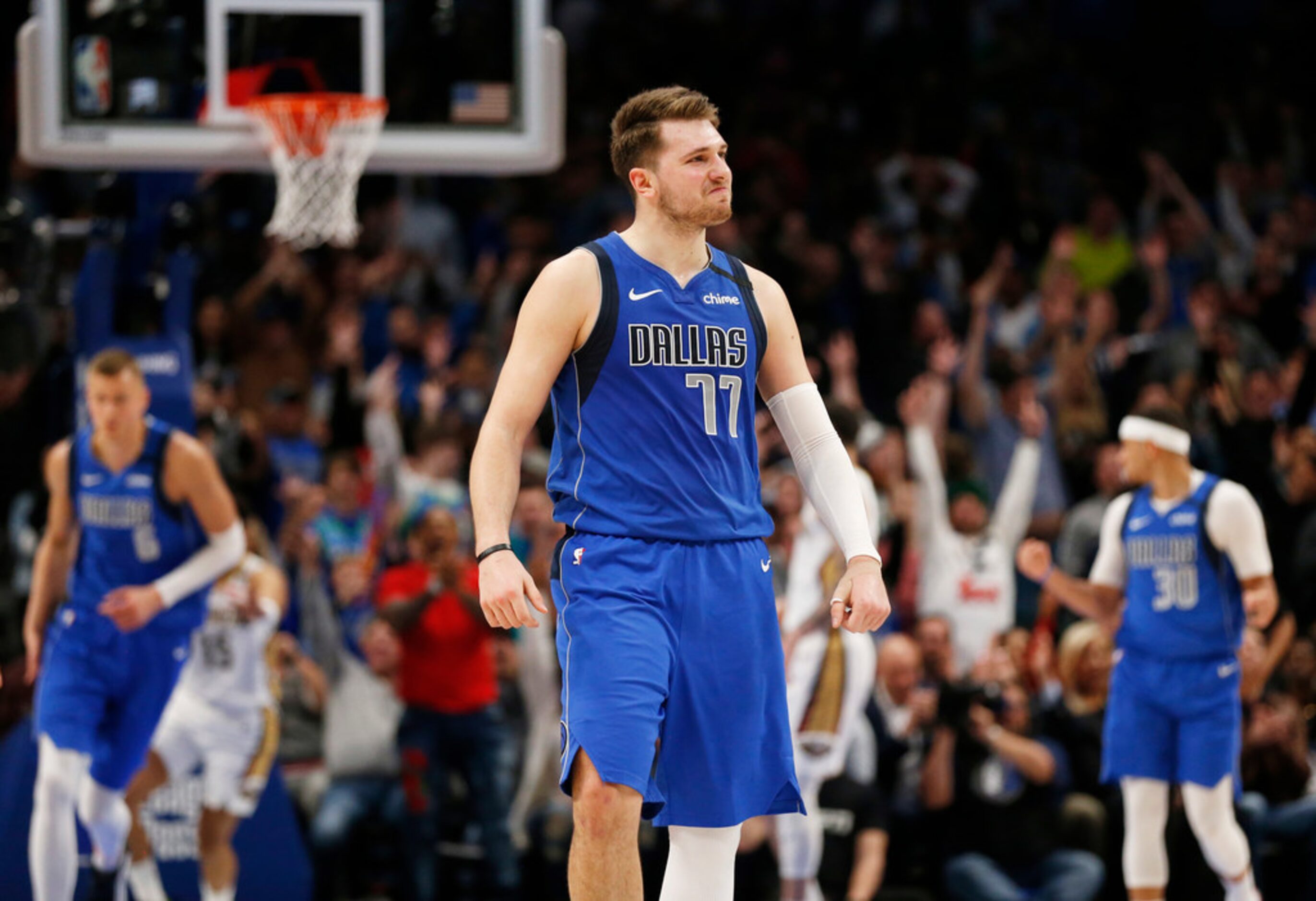 Dallas Mavericks guard Luka Doncic (77) smiles after making a three pointer late in overtime...