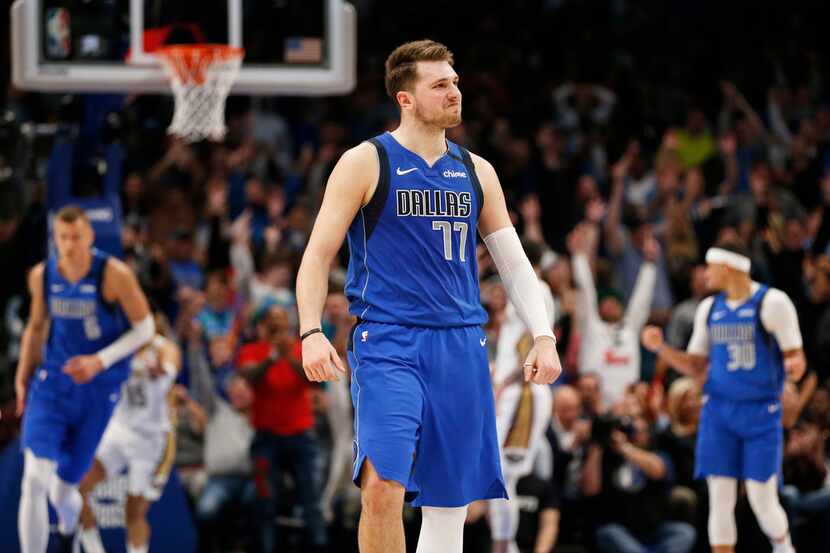 Dallas Mavericks guard Luka Doncic (77) smiles after making a three pointer late in overtime...