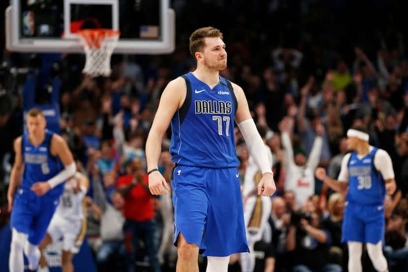 FILE - Mavericks guard Luka Doncic (77) smiles after making a 3-pointer late in overtime...