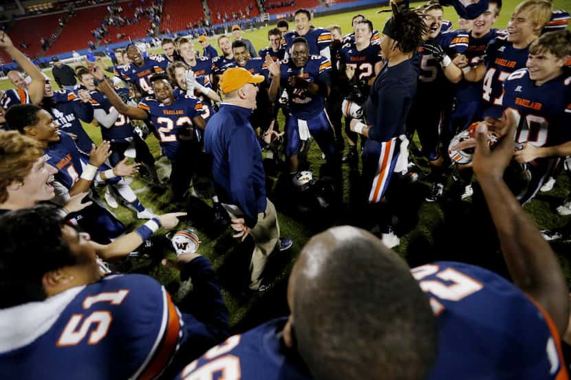 Frisco Wakeland head coach Marty Secord celebrates with his team a 21-13 win over Frisco...