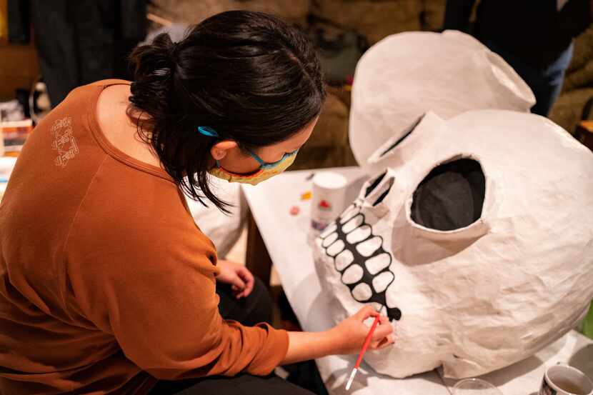 Paloma Salas works on her Day of the Dead puppet on the rainy evening of October 27, 2020 in...