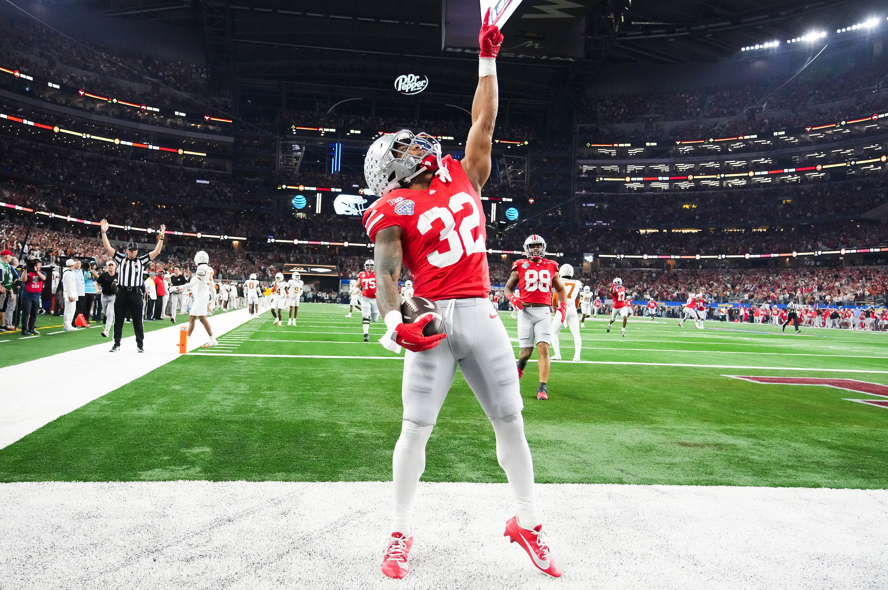 Ohio State running back TreVeyon Henderson (32) celebrates after scoring on a 75-yard...