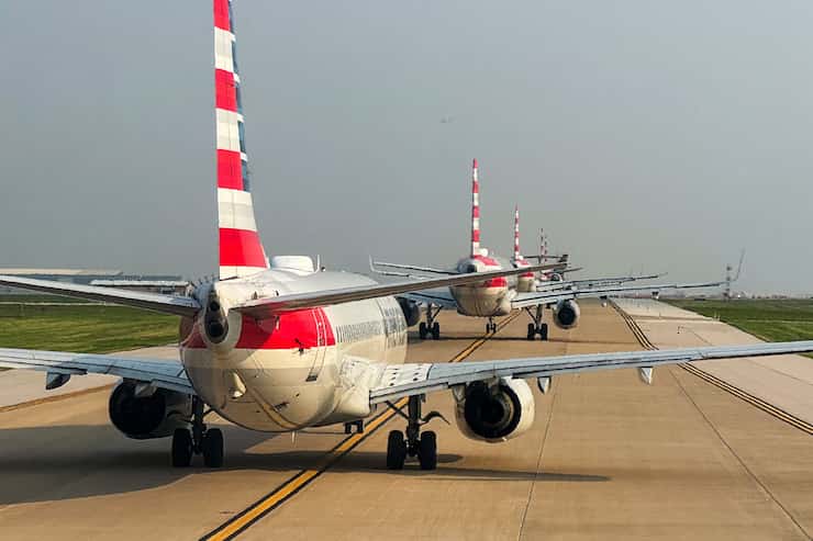 American Airlines planes wait in a long line for takeoff at DFW Airport on Tuesday, May 21,...