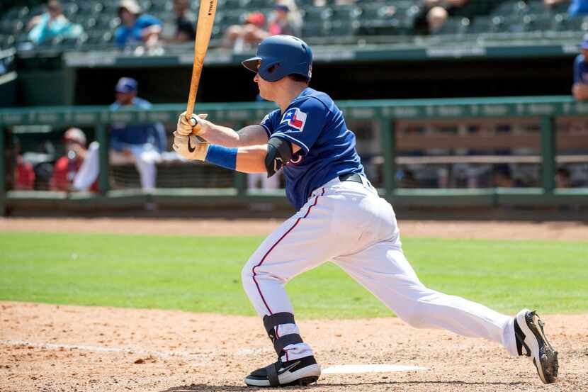 Texas Rangers' Nick Solak follows through on a single off of Los Angeles Angels starting...